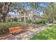 Charming home with a cozy bench, manicured bushes and trees at 5401 Match Point Pl, Lithia, FL 33547