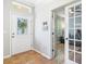 A tiled foyer with a decorative glass front door and a view into a separate room through glass french doors at 5401 Match Point Pl, Lithia, FL 33547