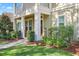 Inviting front porch with cozy seating and well-manicured landscaping leading to front door at 5401 Match Point Pl, Lithia, FL 33547
