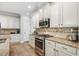 Well-equipped kitchen with stainless steel appliances, granite countertops, and custom backsplash at 5401 Match Point Pl, Lithia, FL 33547