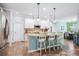 Kitchen island with pendant lighting and barstool seating, open to the adjacent living areas at 5401 Match Point Pl, Lithia, FL 33547