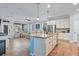 Open-concept kitchen and living area featuring a central island and tile flooring at 5401 Match Point Pl, Lithia, FL 33547