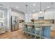 Bright kitchen with white cabinetry, granite countertops, and stainless steel appliances at 5401 Match Point Pl, Lithia, FL 33547