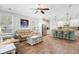 Open living area features tile flooring and a kitchen island with barstool seating at 5401 Match Point Pl, Lithia, FL 33547