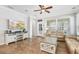 Living room with tile floors, neutral color scheme, ceiling fan, and a wall-mounted television at 5401 Match Point Pl, Lithia, FL 33547
