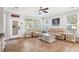 Spacious living room with two couches, a ceiling fan, and large windows for lots of natural light at 5401 Match Point Pl, Lithia, FL 33547