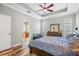 The main bedroom features wood floors and connects to a bathroom; the blue comforter adds a pop of color at 5401 Match Point Pl, Lithia, FL 33547