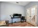 An office area with wood floors next to French doors and staircase features dual monitors on a small desk at 5401 Match Point Pl, Lithia, FL 33547