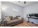 A small office area with wood floors, a ceiling fan, and large windows with plantation shutters for privacy at 5401 Match Point Pl, Lithia, FL 33547