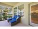 Inviting covered patio with comfortable seating and a view of the kitchen at 5401 Match Point Pl, Lithia, FL 33547