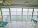 Enclosed balcony offers stunning water views with tile floors, and seating for enjoying the outdoors at 6060 Shore S Dr # 906, Gulfport, FL 33707