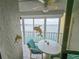 Cozy balcony with seating and water views, accented with decorative dolphin accents and natural light at 6060 Shore S Dr # 906, Gulfport, FL 33707