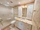 Tastefully updated bathroom with granite countertop, decorative tile, and a glass-enclosed shower at 6060 Shore S Dr # 906, Gulfport, FL 33707