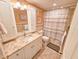 Well-maintained bathroom with granite countertops, tile flooring and shower with tub at 6060 Shore S Dr # 906, Gulfport, FL 33707