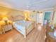 Inviting bedroom featuring light yellow walls, a ceiling fan, and a king-size bed with matching furniture at 6060 Shore S Dr # 906, Gulfport, FL 33707