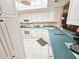 Spacious kitchen with white cabinets, and an adjoining dining room at 6060 Shore S Dr # 906, Gulfport, FL 33707