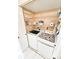 Convenient laundry room with washer, dryer and wire shelving for organized storage at 6060 Shore S Dr # 906, Gulfport, FL 33707