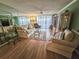 Comfortable living room with laminate flooring, plush seating, and sliding doors to a balcony at 6060 Shore S Dr # 906, Gulfport, FL 33707