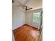 Bright bedroom with hardwood floors, a ceiling fan, and a sliding glass door to the outdoor screened patio at 608 Black Lion Ne Dr, St Petersburg, FL 33716