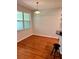 Cozy dining area with a large window providing natural light and hardwood floors at 608 Black Lion Ne Dr, St Petersburg, FL 33716