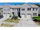 Charming two-story townhouse with attached garages, well-maintained landscaping, and a welcoming entrance at 608 Black Lion Ne Dr, St Petersburg, FL 33716