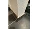 View of dark tile floor and wall corner with baseboard; the tile has a subtle textured finish at 608 Black Lion Ne Dr, St Petersburg, FL 33716
