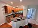 Bright kitchen featuring wooden cabinets, stainless steel appliances, a breakfast bar, and hardwood flooring at 608 Black Lion Ne Dr, St Petersburg, FL 33716