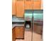 Close up of a refrigerator, and kitchen cabinets with stone countertops at 608 Black Lion Ne Dr, St Petersburg, FL 33716