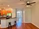 Open-concept living space with hardwood floors, recessed lighting, and a view of the kitchen and entryway at 608 Black Lion Ne Dr, St Petersburg, FL 33716
