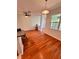 Spacious living area with hardwood floors, ceiling fan, and access to a screened lanai at 608 Black Lion Ne Dr, St Petersburg, FL 33716