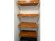 Modern shelving unit, made with sleek wood, adorns this room with black tile flooring below at 608 Black Lion Ne Dr, St Petersburg, FL 33716