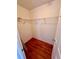 Walk-in closet with wood flooring and shelving at 608 Black Lion Ne Dr, St Petersburg, FL 33716