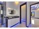 Stylish bathroom featuring illuminated mirror, a sleek vanity, and a frosted door at 6534 Simone Shores Cir, Apollo Beach, FL 33572