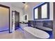 A modern bathroom features a soaking tub and lighted mirror at 6534 Simone Shores Cir, Apollo Beach, FL 33572