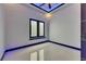 Modern bedroom showcasing tile floors, accent lighting, and a large window for natural light at 6534 Simone Shores Cir, Apollo Beach, FL 33572