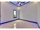 A bright room featuring recessed lighting, modern ceiling fan, and a large black framed window with LED accent lighting at 6534 Simone Shores Cir, Apollo Beach, FL 33572