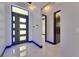 Modern foyer with sleek lighting, porcelain floors, and a clear view into the hallway at 6534 Simone Shores Cir, Apollo Beach, FL 33572