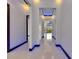 Bright hallway with porcelain floors, recessed lighting, and modern light fixtures at 6534 Simone Shores Cir, Apollo Beach, FL 33572
