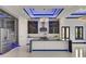 Modern kitchen boasts an island, stainless appliances, and recessed lighting with dark cabinets at 6534 Simone Shores Cir, Apollo Beach, FL 33572
