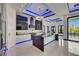 Modern kitchen boasts an island, stainless appliances, and recessed lighting with dark cabinets at 6534 Simone Shores Cir, Apollo Beach, FL 33572