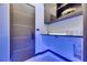 Contemporary laundry room featuring sleek cabinets, a counter with accent lighting, and modern fixtures at 6534 Simone Shores Cir, Apollo Beach, FL 33572