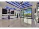 Open-concept living room featuring tile floors, accent lighting, island, and sliding glass doors at 6534 Simone Shores Cir, Apollo Beach, FL 33572