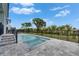 Enjoy the backyard swimming pool with a serene landscape, perfect for relaxation and fun at 6534 Simone Shores Cir, Apollo Beach, FL 33572