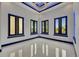 An open room with dark trim windows and light gray walls reflects light on the tile floor at 6534 Simone Shores Cir, Apollo Beach, FL 33572
