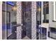 Elegant shower with black marble tile and designer fixtures at 6534 Simone Shores Cir, Apollo Beach, FL 33572
