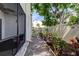 View of the well-maintained backyard and screened porch with gravel, plants, and flower beds at 700 Starkey Rd # 1216, Largo, FL 33771