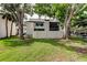 Beautiful backyard view with mature trees, grassy lawn, and a white privacy fence at 700 Starkey Rd # 1216, Largo, FL 33771