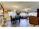 Open dining and living room features modern chandelier lighting and a bar area at 700 Starkey Rd # 1216, Largo, FL 33771