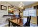 Dining room with open concept featuring dark wood dining table and modern chandelier at 700 Starkey Rd # 1216, Largo, FL 33771