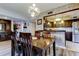 This dining room is open to the kitchen, featuring modern lighting and a stylish, tiled half wall at 700 Starkey Rd # 1216, Largo, FL 33771